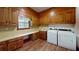 Laundry room with washer, dryer, sink, and ample cabinet space for storage, plus a window for natural light at 993 Castle Falls Dr. Ne Dr, Atlanta, GA 30329