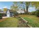 Beautifully landscaped backyard with detached garage, mature trees, and plenty of green space at 108 Kirk Crossing Dr, Decatur, GA 30030