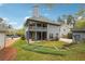 Expansive backyard featuring a two-story home with a covered porch and lush landscaping at 108 Kirk Crossing Dr, Decatur, GA 30030