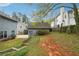 Backyard featuring detached garage, lush landscaping, and mature trees at 108 Kirk Crossing Dr, Decatur, GA 30030