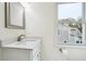 Bathroom with white vanity, quartz countertop, and a window offering natural light at 108 Kirk Crossing Dr, Decatur, GA 30030
