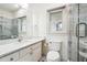 Bright bathroom featuring a gray-tiled shower, white vanity, and large mirror for a refreshing and modern space at 108 Kirk Crossing Dr, Decatur, GA 30030