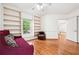 Cozy bedroom featuring hardwood floors, a sitting area, and built-in bookshelves at 108 Kirk Crossing Dr, Decatur, GA 30030
