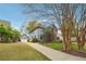 Charming home featuring a brick facade, blue siding, mature trees, and a well-manicured lawn at 108 Kirk Crossing Dr, Decatur, GA 30030