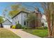 Charming home featuring a brick facade, blue siding, mature trees, and a well-manicured lawn at 108 Kirk Crossing Dr, Decatur, GA 30030