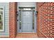 Elegant front door with sidelights, brick surround, and stylish exterior lighting at 108 Kirk Crossing Dr, Decatur, GA 30030