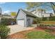 Detached garage with a gray door situated in a landscaped backyard at 108 Kirk Crossing Dr, Decatur, GA 30030