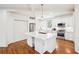 Modern kitchen featuring white cabinetry, a spacious island, stainless steel appliances, and hardwood floors at 108 Kirk Crossing Dr, Decatur, GA 30030