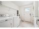 Bright laundry room featuring a Maytag washer and dryer, wire shelving, and direct exterior access at 108 Kirk Crossing Dr, Decatur, GA 30030