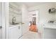 Well-lit laundry room with sink, cabinets, granite counters, and easy access to kitchen and pantry at 108 Kirk Crossing Dr, Decatur, GA 30030