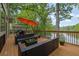 Inviting back deck with lake view, an orange umbrella, and an outdoor seating arrangement at 132 Lakeshore Dr, Roswell, GA 30075
