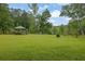 Expansive backyard featuring a gazebo, lush lawn, mature trees, and lake views, perfect for outdoor enjoyment at 132 Lakeshore Dr, Roswell, GA 30075