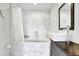 Bright bathroom featuring a marble tile shower, soaking tub, and modern fixtures at 132 Lakeshore Dr, Roswell, GA 30075