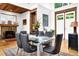 Elegant dining room with stone fireplace, wood ceiling, and modern furnishings, providing a warm, inviting ambiance at 132 Lakeshore Dr, Roswell, GA 30075