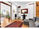 Bright entryway featuring hardwood floors, a rustic accent wall, and seamless access to other living areas and a guest bathroom at 132 Lakeshore Dr, Roswell, GA 30075