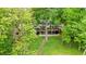 Contemporary two-story home with large windows and spacious deck, surrounded by lush greenery and mature trees at 132 Lakeshore Dr, Roswell, GA 30075