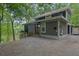 Unique contemporary home with modern design, featuring a gravel driveway, lakeside view and ample natural light at 132 Lakeshore Dr, Roswell, GA 30075
