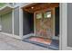 Close up of front entrance featuring rustic metal double doors, a wooden ceiling, and a modern grey trimmed entryway at 132 Lakeshore Dr, Roswell, GA 30075
