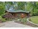 Charming cottage home with cedar siding, a covered front porch and landscaped front yard, offering curb appeal at 132 Lakeshore Dr, Roswell, GA 30075