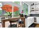 Stylish kitchen featuring an island with bar seating, white cabinets, stainless steel appliances, and picturesque outdoor views at 132 Lakeshore Dr, Roswell, GA 30075