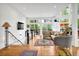 Bright and airy living room with hardwood floors, large windows, and access to a deck with nature views at 132 Lakeshore Dr, Roswell, GA 30075