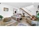 Spacious living room with cozy furniture, bright lighting, and rustic staircase at 132 Lakeshore Dr, Roswell, GA 30075