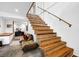 Unique wooden staircase with metal railing, complemented by comfortable seating area at 132 Lakeshore Dr, Roswell, GA 30075