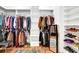 Bright walk-in closet featuring custom shelving, hanging racks, and a full-length mirror at 132 Lakeshore Dr, Roswell, GA 30075