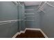Walk-in closet features wire shelving, hardwood floors and neutral walls at 207 Bridge Se Ln, Smyrna, GA 30082