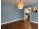 Dining area boasts hardwood floors, floating shelves and stylish light fixture with a view into the bright kitchen at 207 Bridge Se Ln, Smyrna, GA 30082