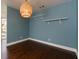 Dining area showcases hardwood floors, floating shelves and stylish light fixture with access to the front entrance at 207 Bridge Se Ln, Smyrna, GA 30082