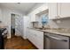 Bright galley kitchen features stainless steel appliances, granite countertops and white cabinetry at 207 Bridge Se Ln, Smyrna, GA 30082