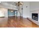 Open-concept living room featuring a spiral staircase, fireplace, hardwood floors, and high ceilings at 207 Bridge Se Ln, Smyrna, GA 30082