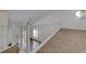 Bright, carpeted loft space with a white railing, and natural light from a circular window at 207 Bridge Se Ln, Smyrna, GA 30082