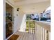 Inviting covered porch with wood floors, a glass door, and a view of the street at 207 Bridge Se Ln, Smyrna, GA 30082
