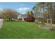 Expansive backyard with mature trees, deck, above ground pool, and lovely landscaping at 21 Enclave Walk, Powder Springs, GA 30127