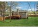 Fenced backyard with mature trees and deck, ideal for outdoor living and entertaining at 21 Enclave Walk, Powder Springs, GA 30127
