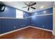 Finished basement space with blue walls, hardwood floors, and recessed lighting at 21 Enclave Walk, Powder Springs, GA 30127
