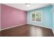 Brightly painted bedroom with hardwood floors and natural light from a large window at 21 Enclave Walk, Powder Springs, GA 30127