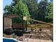 Outdoor deck with a seating area and a shaded pergola, perfect for entertaining by the pool at 21 Enclave Walk, Powder Springs, GA 30127
