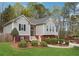 Charming home with gray siding, red brick accents, and a beautifully landscaped front yard at 21 Enclave Walk, Powder Springs, GA 30127