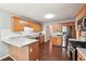 Kitchen with wood cabinets, stainless appliances and hardwood floors offers ample countertop space at 21 Enclave Walk, Powder Springs, GA 30127