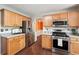 Well-appointed kitchen with stainless steel appliances, hardwood floors, and wood cabinets at 21 Enclave Walk, Powder Springs, GA 30127