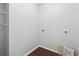 Simple laundry room with white walls, hardwood floors, and washer/dryer hookups at 21 Enclave Walk, Powder Springs, GA 30127