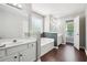 Bright main bathroom with double vanity, soaking tub, and separate water closet at 21 Enclave Walk, Powder Springs, GA 30127