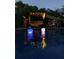 Poolside view at dusk with mood lighting, perfect for evening relaxation and entertaining at 21 Enclave Walk, Powder Springs, GA 30127