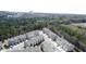 An aerial view of newly constructed grey townhomes surrounded by a beautiful forest at 308 Overture Ct, Smyrna, GA 30080