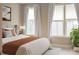 Comfortable bedroom with a cozy bed, brightened by natural light streaming through multiple windows and white curtains at 308 Overture Ct, Smyrna, GA 30080