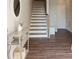 Welcoming entryway featuring wood floors, staircase, console table, and modern decor accents at 308 Overture Ct, Smyrna, GA 30080