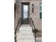 Inviting front door with brick facade, black handrails, and a stylish door number plaque at 308 Overture Ct, Smyrna, GA 30080